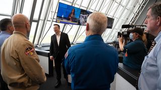 SpaceX CEO Elon Musk speaks with NASA personnel after the successful launch of Demo-2 on May 30, 2020, in the Launch Control Center at NASA's Kennedy Space Center.