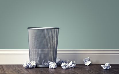 office garbage near metal basket