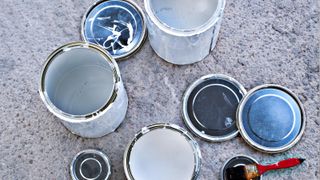 Top down shot of various opened tins of paint