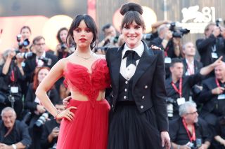 Jenna Ortega in a red dress and Winona Ryder in a black blazer and white button down with a black skirt at the Beetlejuice Beetlejuice premiere at the Venice International Film Fesitval on August 28.