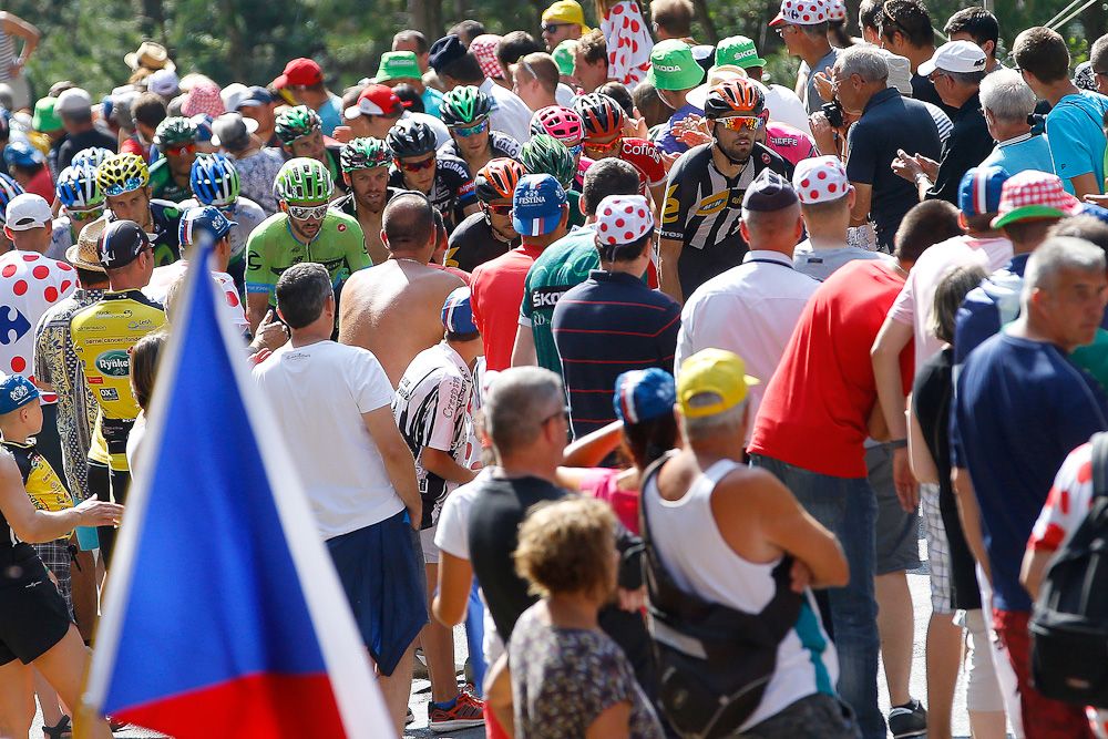 Riders can hardly be seen among the spectators.