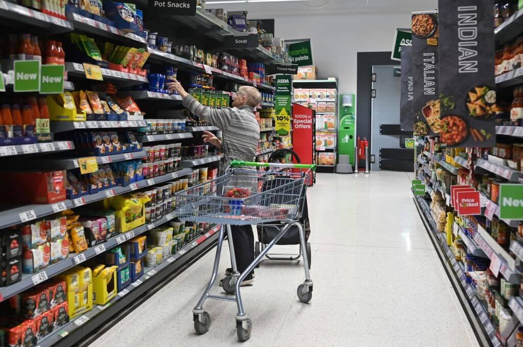 A customer looks at some goods at the Asda supermarket