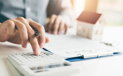 picture of homeowner using a calculator