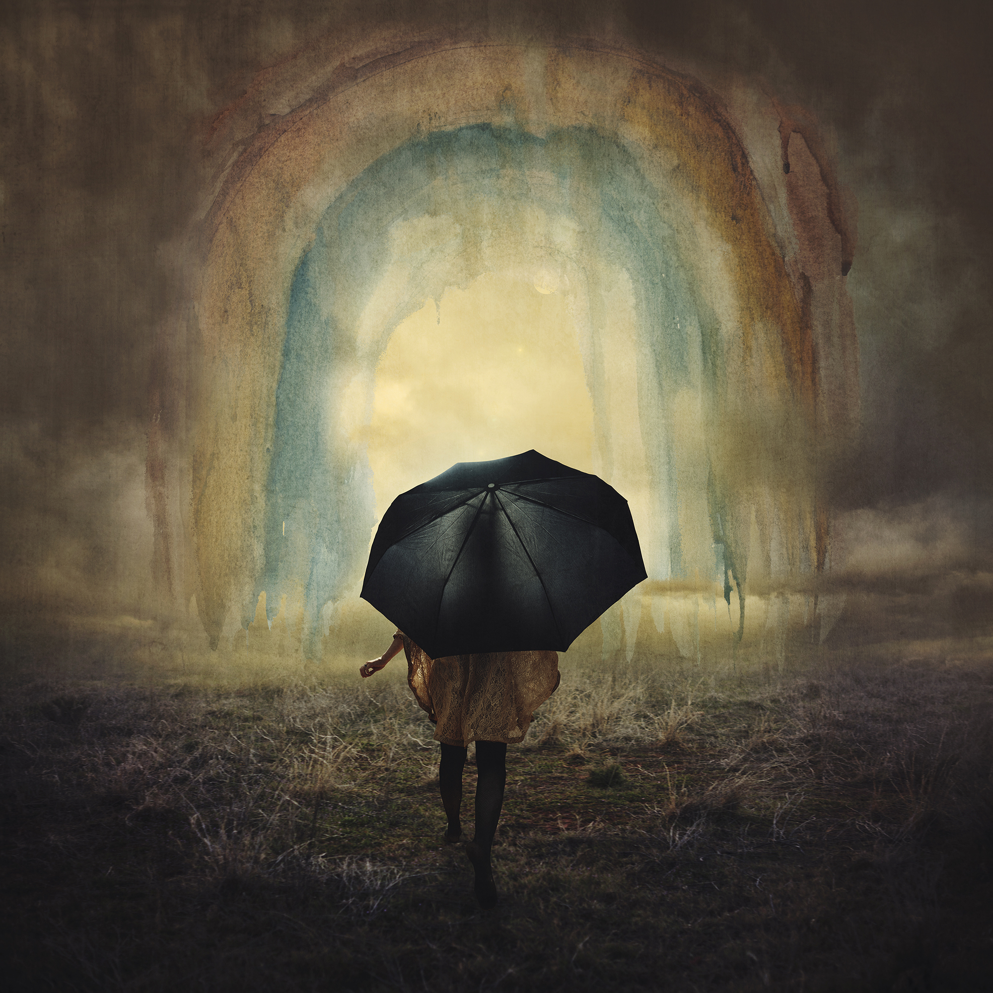 A person holds an umbrella under a gloomy painted rainbow