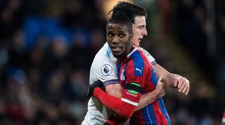 West Ham's Declan Rice holds Crystal Palace's Wilfried Zaha during a Premier League game in 2019.