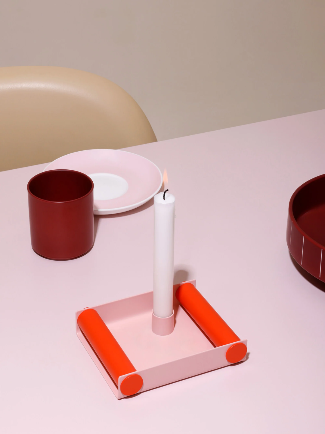A pink and orange candle holder Tray from Design Letters