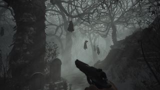 A spooky forest with hanging dolls