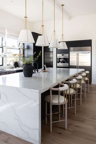 Monochrome kitchen design with marble island and pendant lights