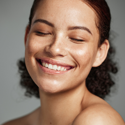 Model with glowing skin smiling
