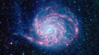 An image of the stunning pinwheel galaxy, which looks like a twirling spiral of pink and purple light