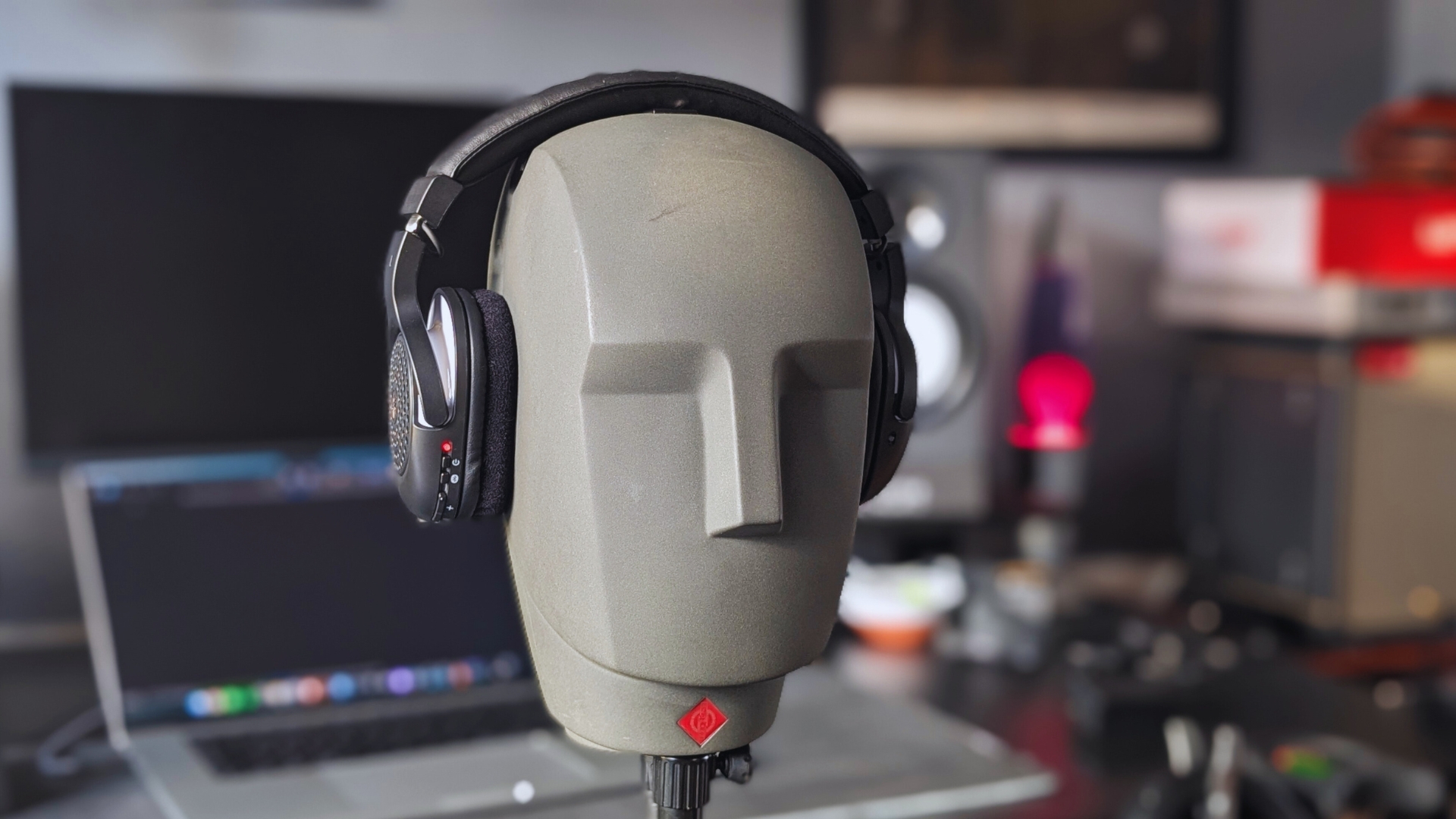 A pair of Yamaha YH-WL500 wireless headphones on a Neumann KU 100 dummy head