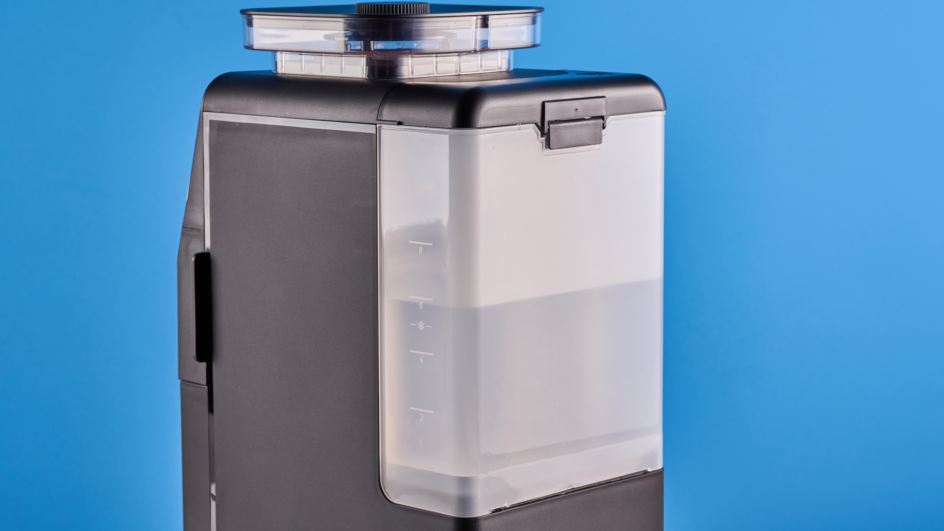 the gevi 10-cup drip coffee maker with grinder photographed against a blue background, showing the glass carafe, water tank, touch screen, and accessories including plastic filter