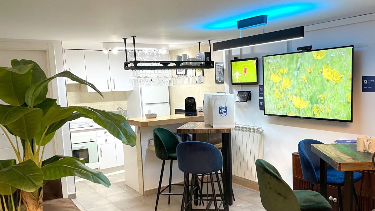 The PPDS Studios kitchen-type area with Philips displays and high-top tables for conversations.