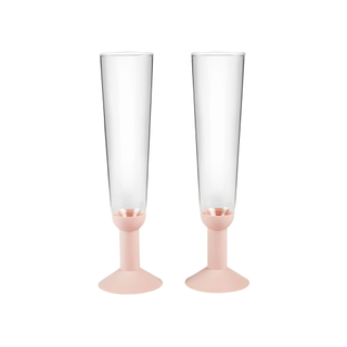 two champagne flutes with light pink bases