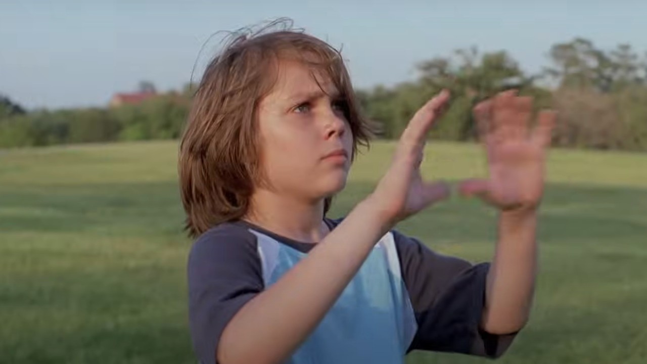 Ellar Coltrane preparing to catch a football in Boyhood