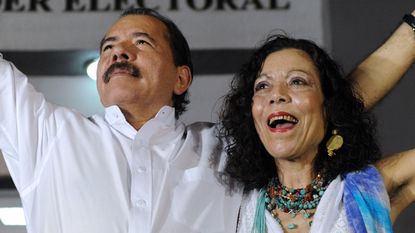 Nicaraguan President Daniel Ortega (L) celebrates with First Lady Rosario Murillo after receiving the credentials in Managua on January 9, 2012, a day before his re-inauguration. AFP PHOTO/Ro