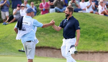Baldwin celebrates with his caddie after his victory