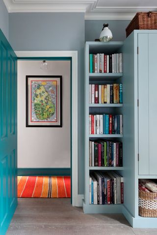 Built in bookshelves in a blue bedroom