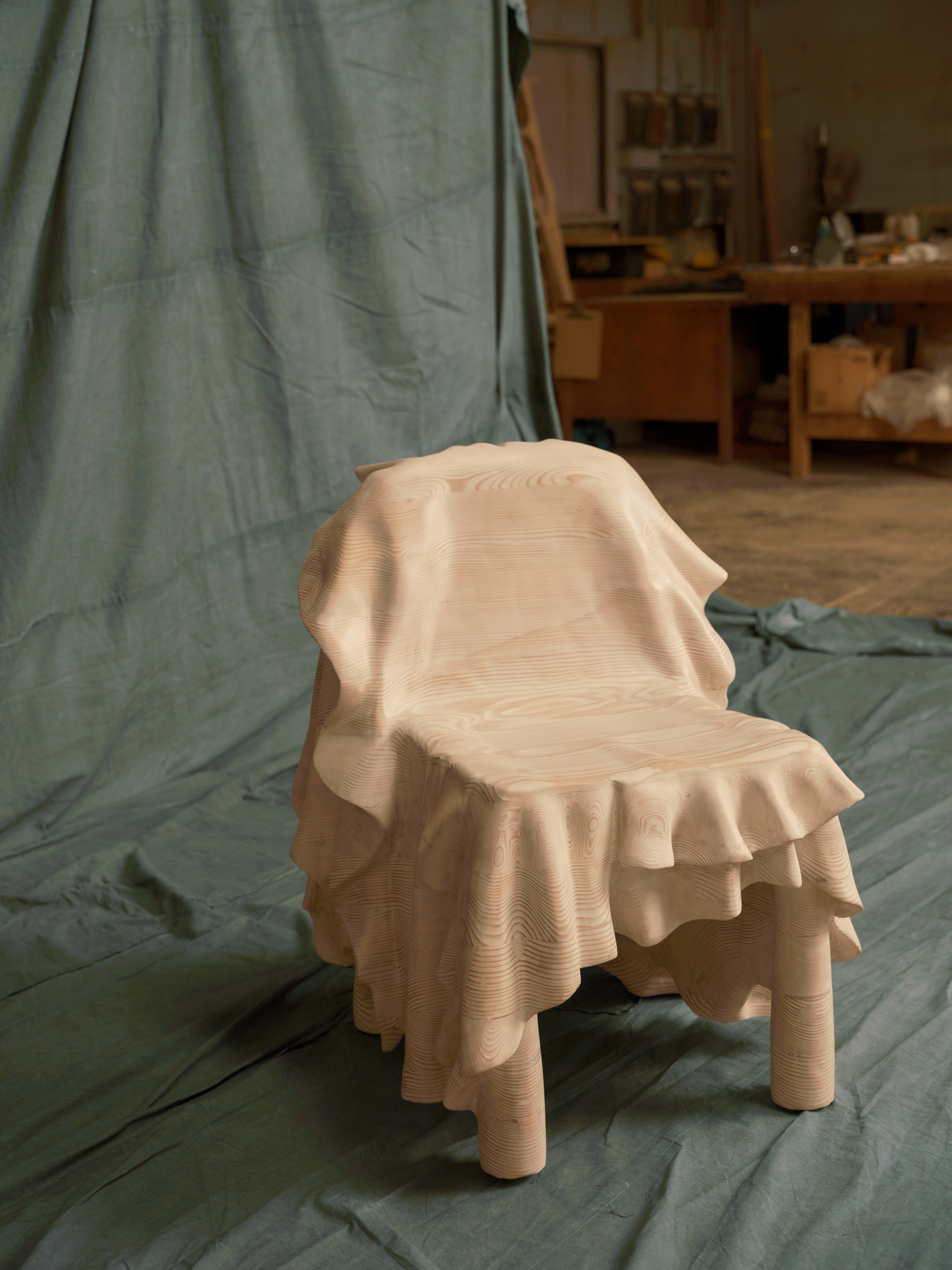 a wood chair carved to look like fabric