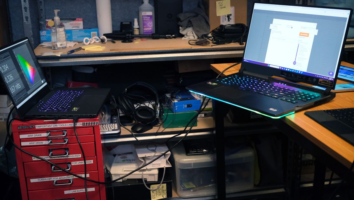 Two open and powered on laptops connected with a cable.