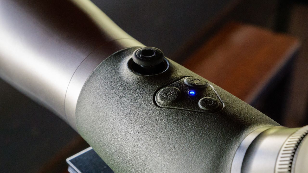 Bird spotting scope on tripod in bird watching hide