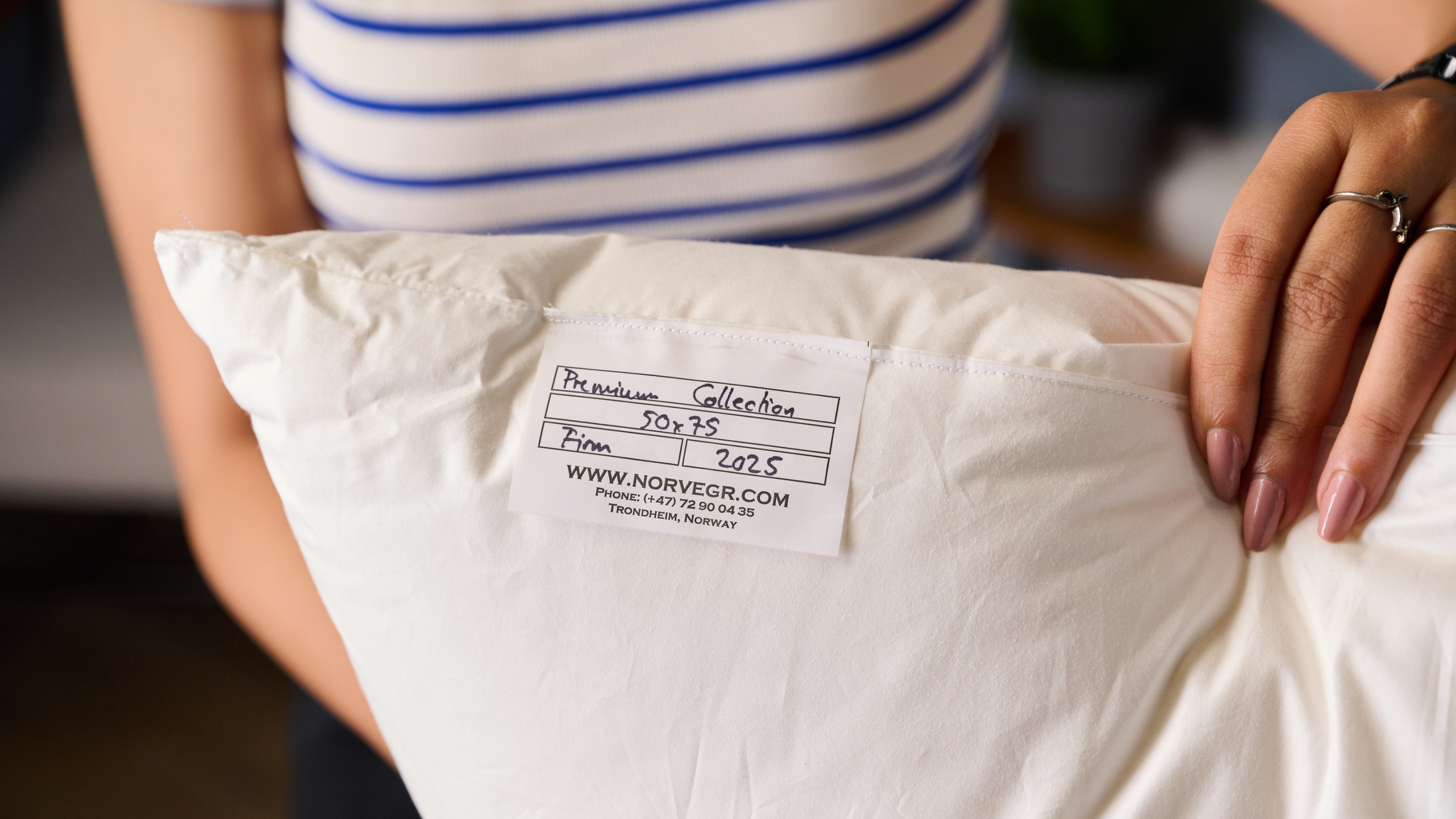 A close-up shot of the Norvegr European White Goose 100% Down Firm Pillow tag