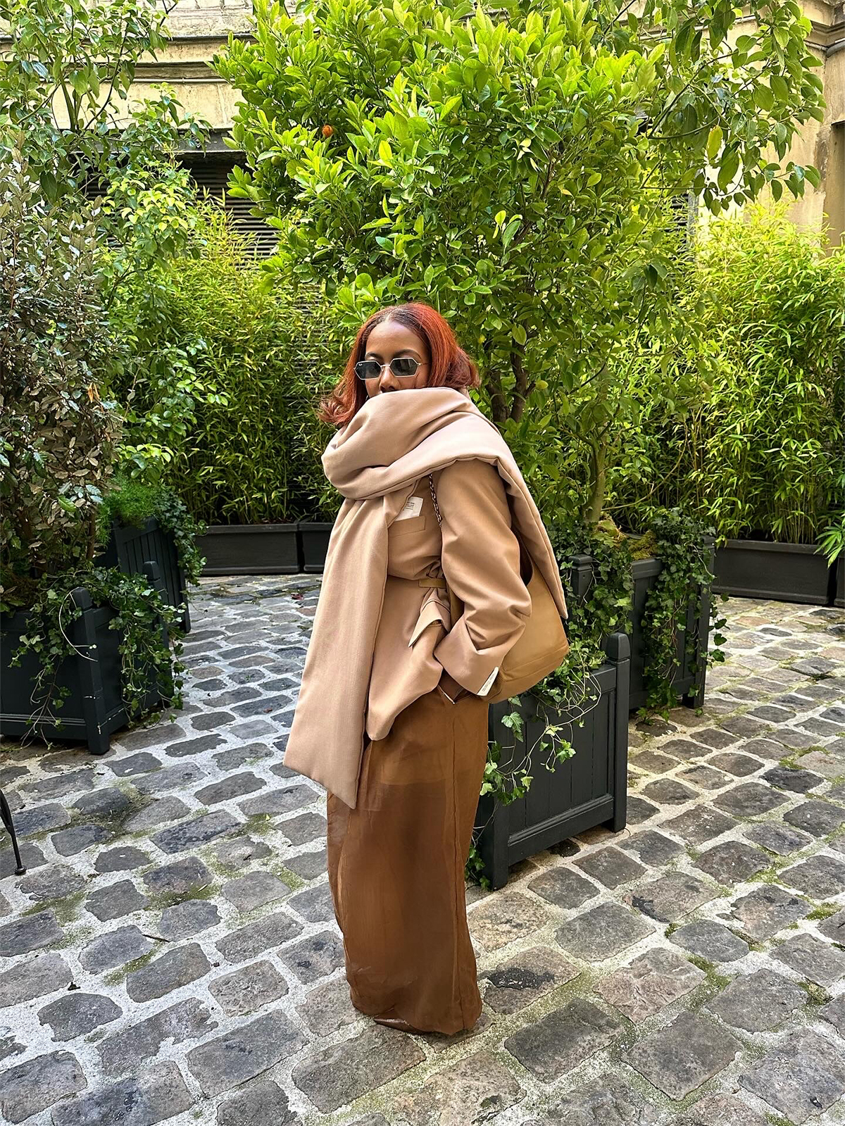 Tiffany Reid wearing a tan coat and pants during fashion week.