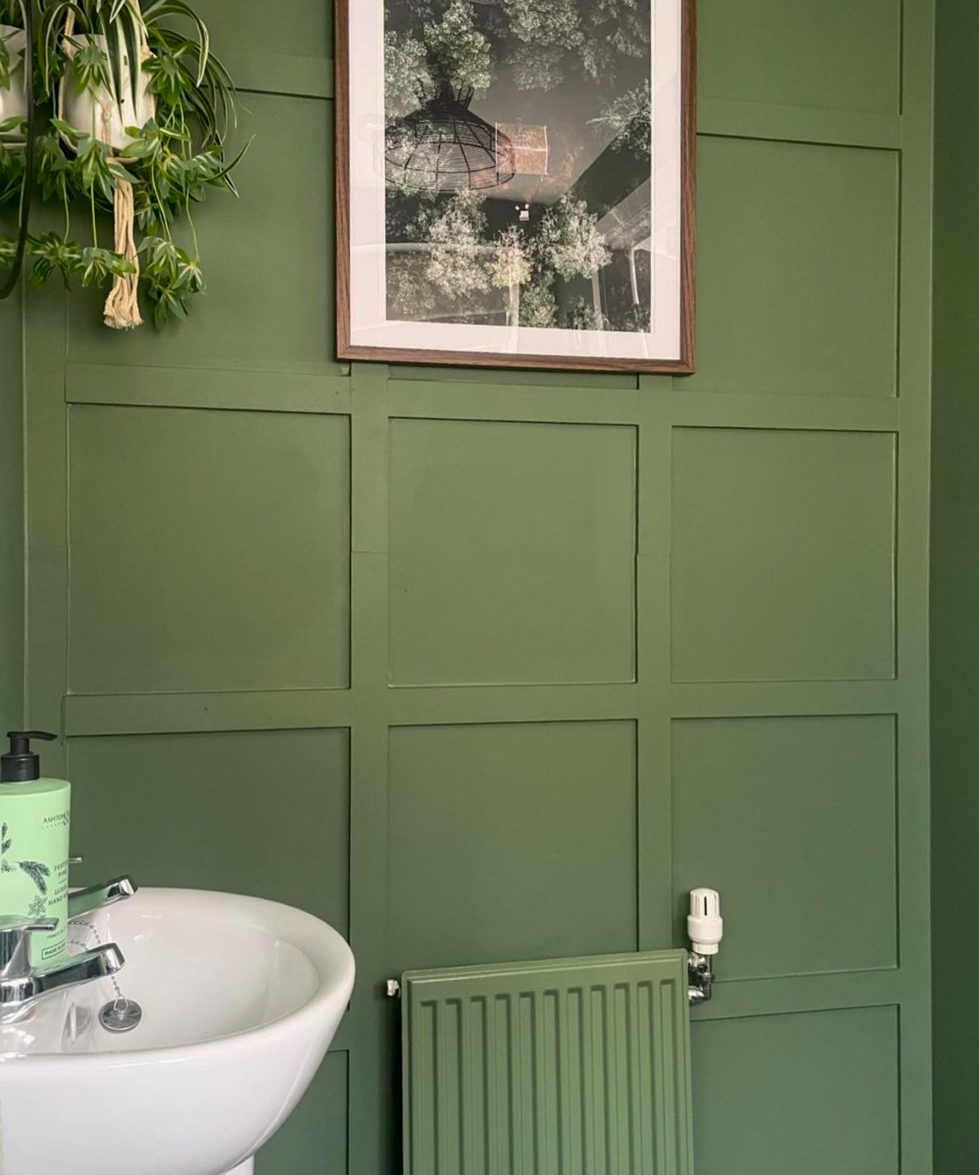 bathroom with green shaker style wall panelling