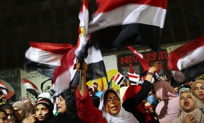 People dance and cheer in Tahrir Square the day after former Egyptian President Mohammed Morsi was ousted from power.