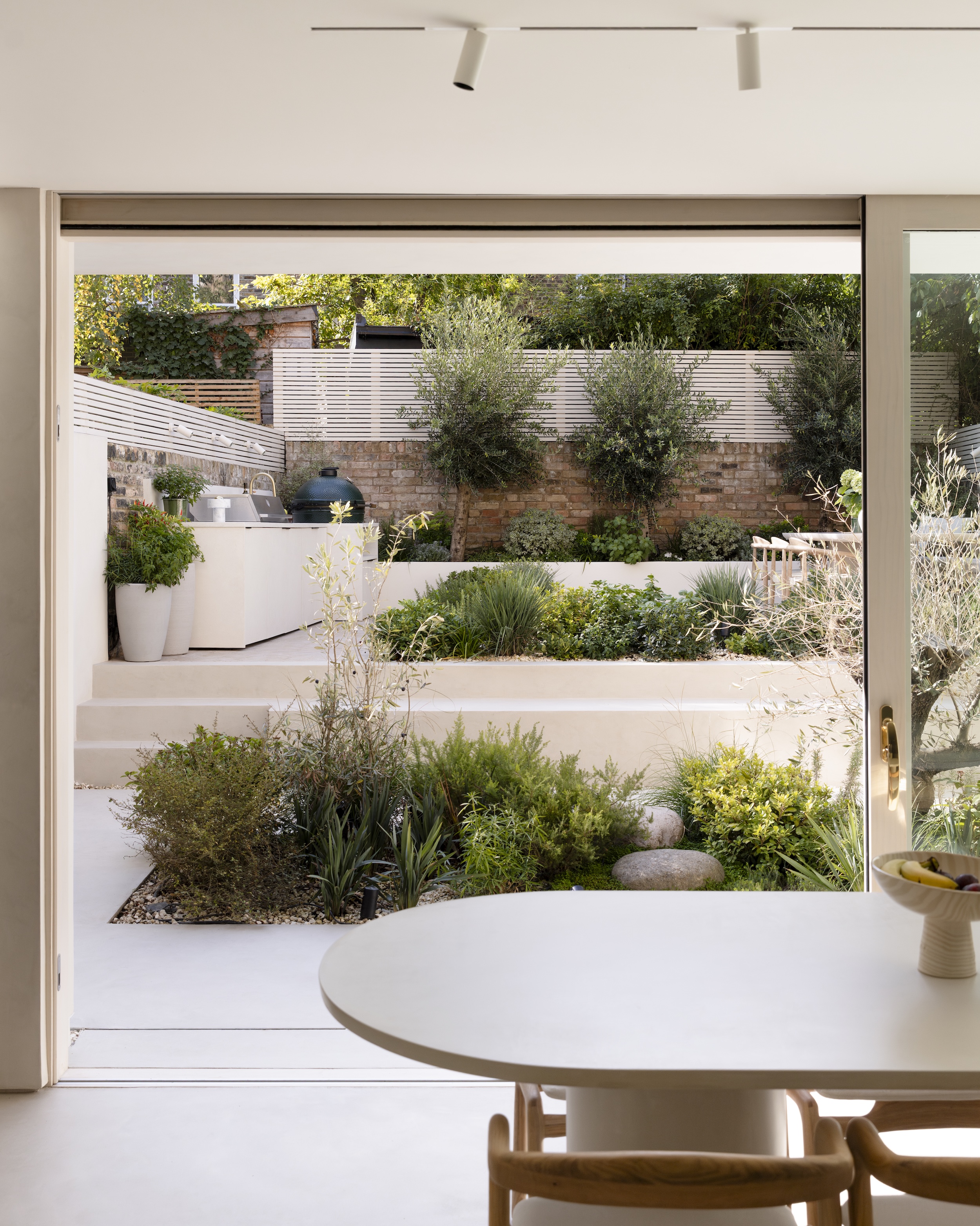 a view outside of a home to mediterranean garden in london with an outdoor