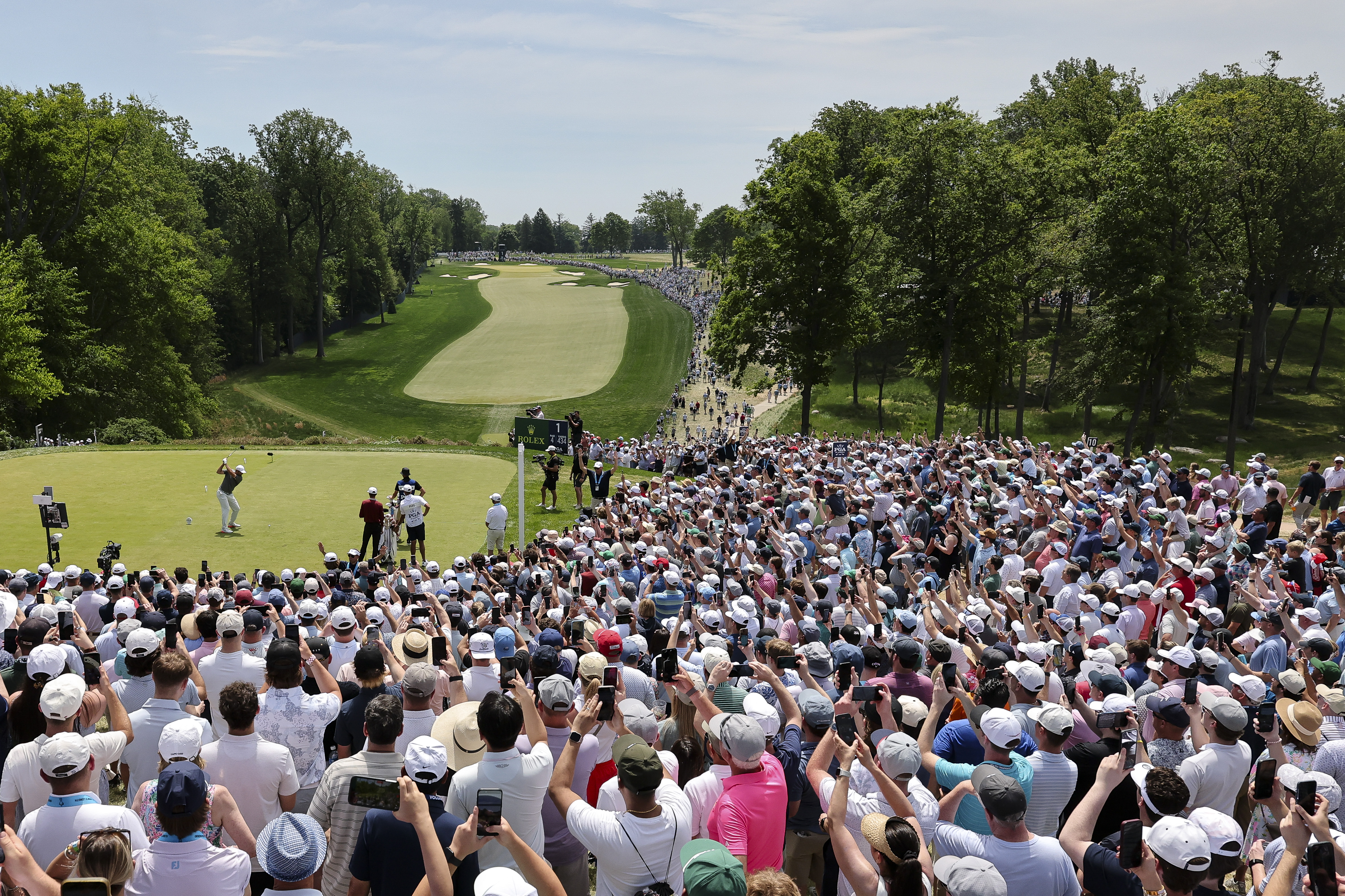 Scottie Scheffler tees off the 1st hole at the PGA Championship in front of a huge crowd