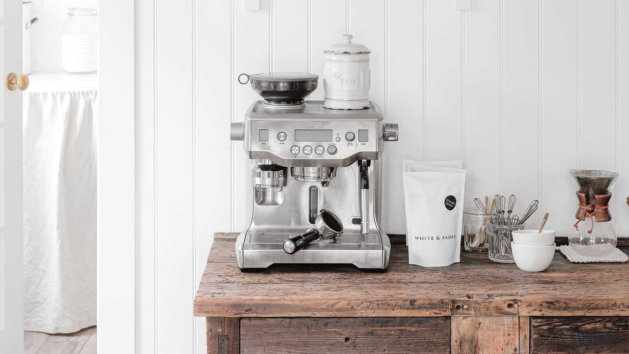 a coffee maker on a piece of wood furniture