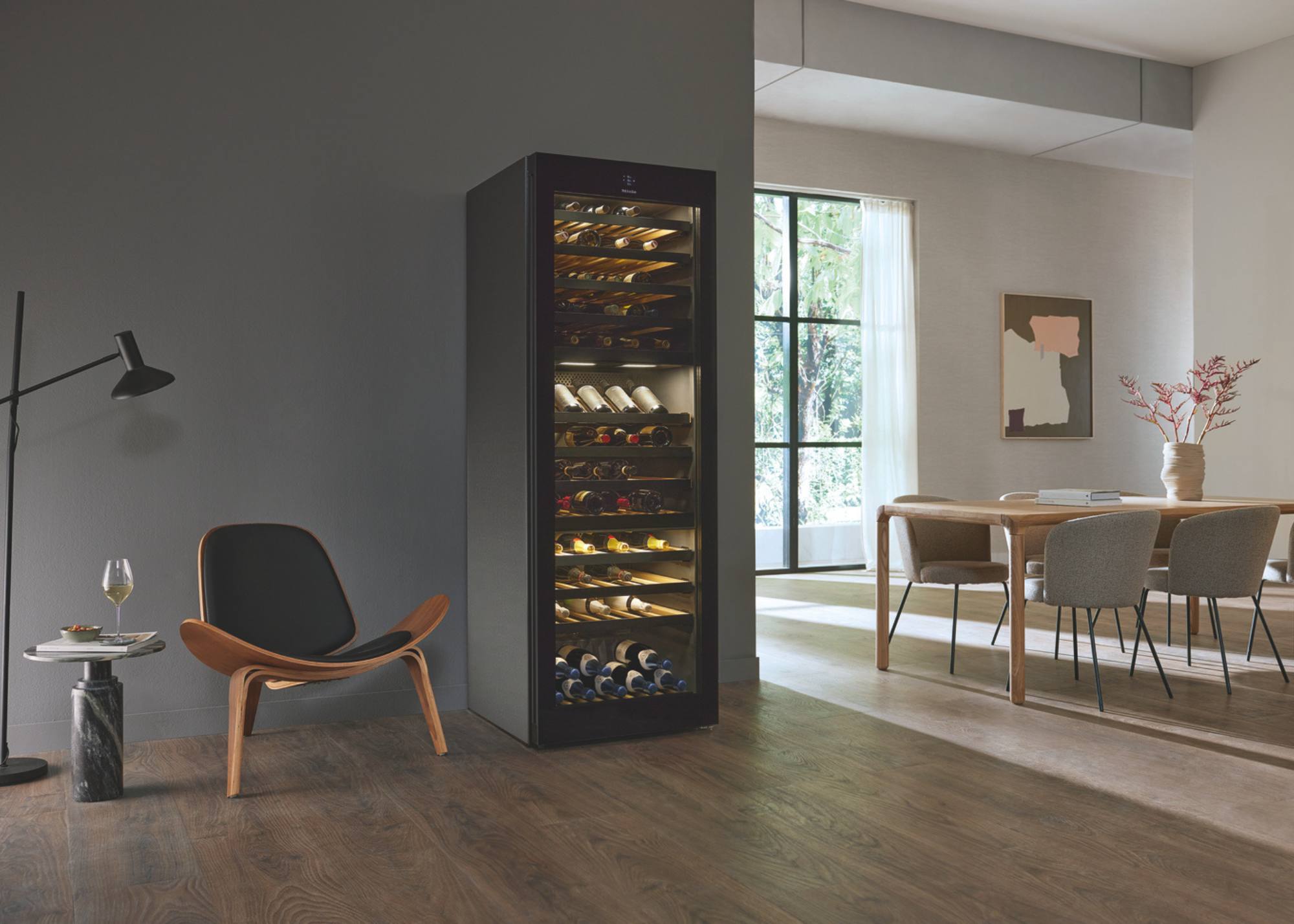 Miele wine fridge in a modern home in an open plan kitchen with a view of the dining area