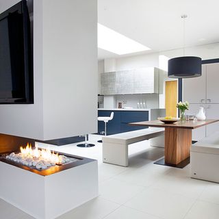 kitchen room with fireplace and white tiled flooring