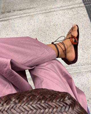 Woman wearing tie-up gladiator sandals with stone detail.