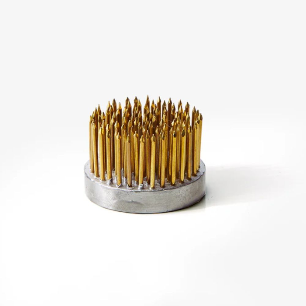 small flower frog with brass pins on white background