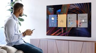 Samsung TV on stand with person in front with phone