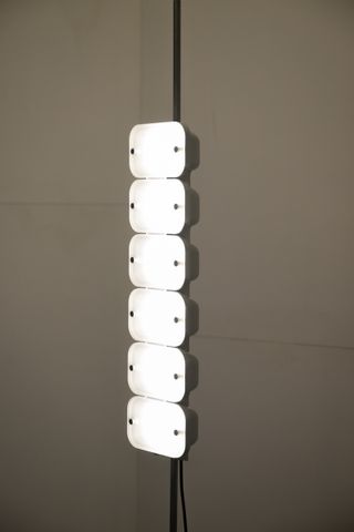 Six light modules by Chinese design brand Bias. stacked on top of each other vertically to form a lamp