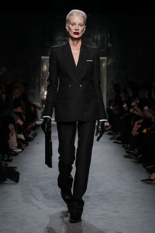 A model wearing a suit walking in Haider Ackermann's first Tom Ford runway show during Paris Fashion Week.