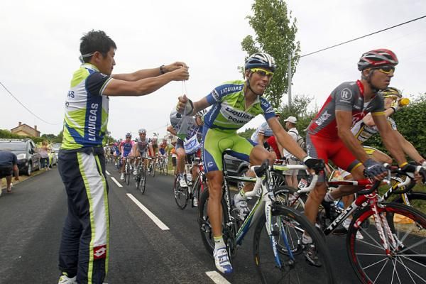 A Liquigas-Doimo rider collects his musette in the feed zone.