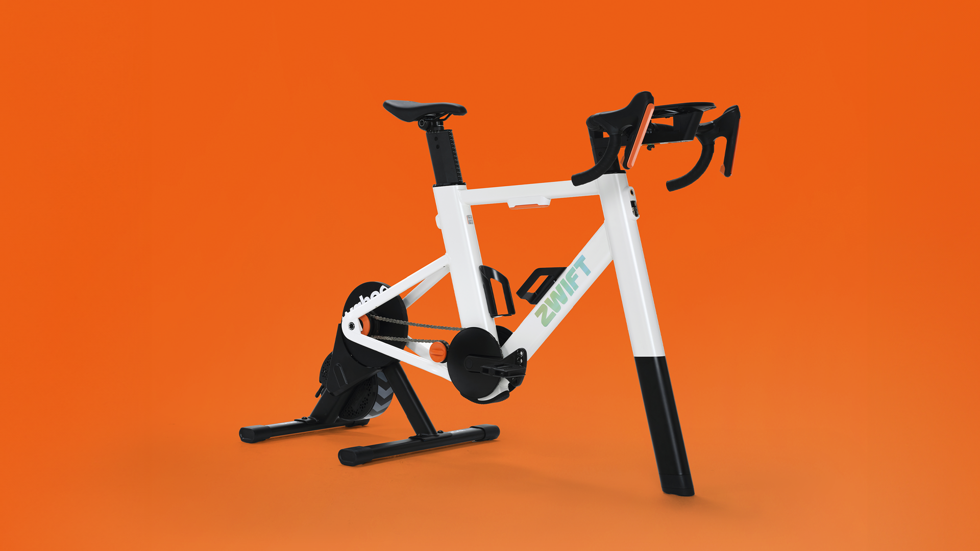 A studio photo of a Zwift Ride V2 frame, on an orange background