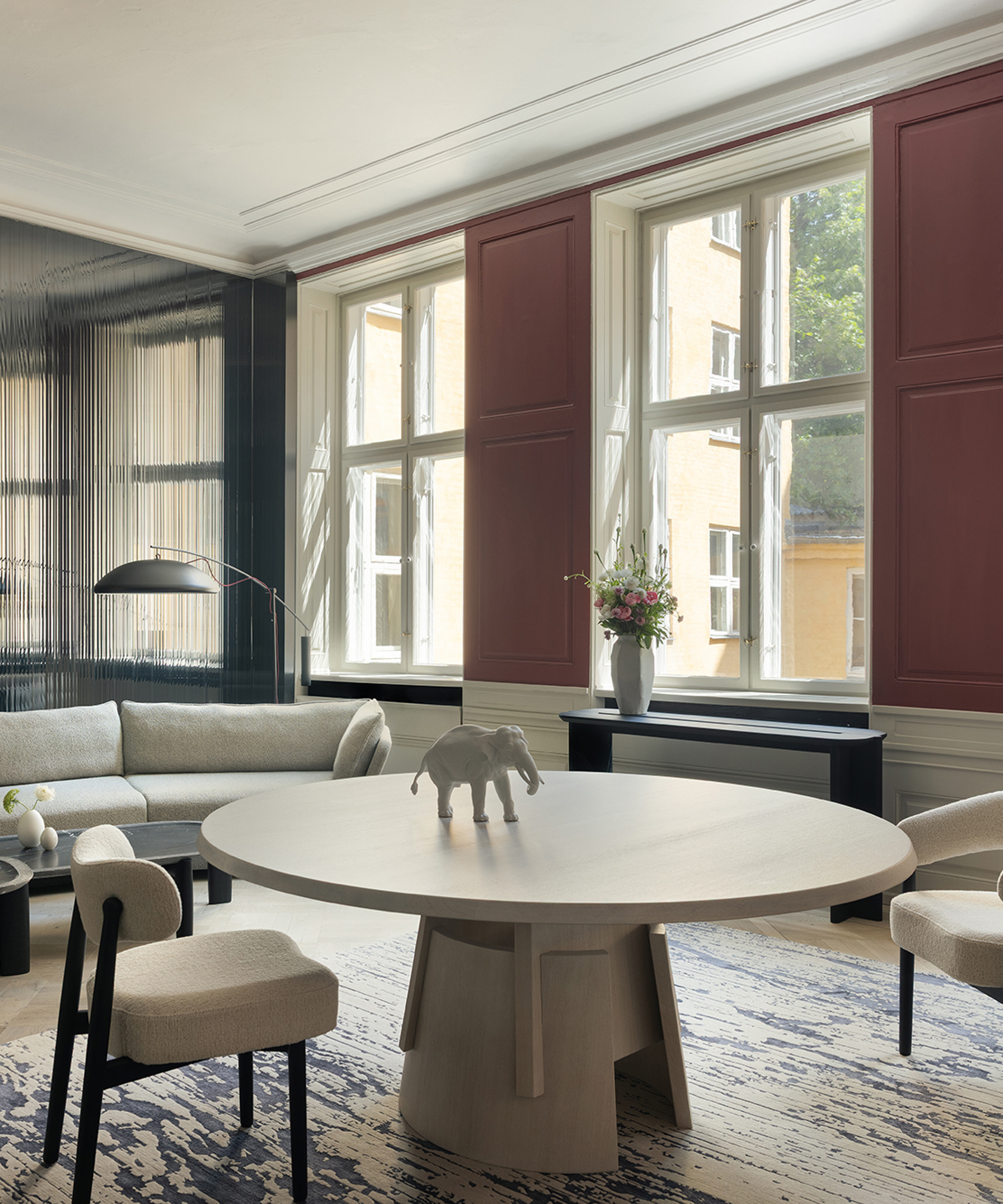 large round white table in an open plan living room