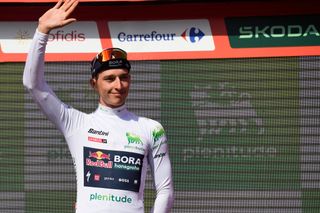 The best young rider, Team Bora's Florian Lipowitz celebrates on the podium wearing the white jersey after the stage 6 of La Vuelta a Espana cycling tour, a 185.5 km race between Jerez de la Frontera and Yunquera, on August 22, 2024. (Photo by CRISTINA QUICLER / AFP)