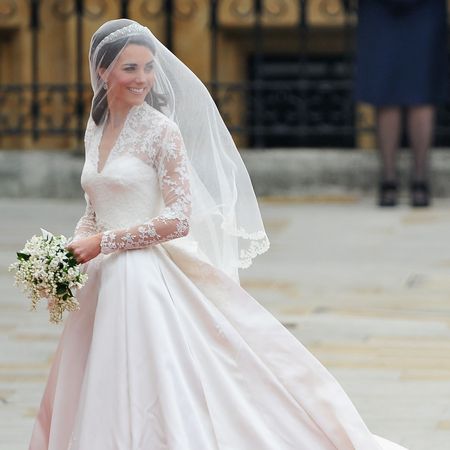 Princess Kate wearing her wedding gown and veil looking to the right