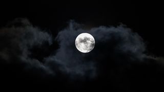the full moon in a dark night sky
