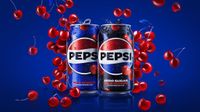Promo shot showing two cans of Pepsi Wild Cherry surrounded by falling cherries
