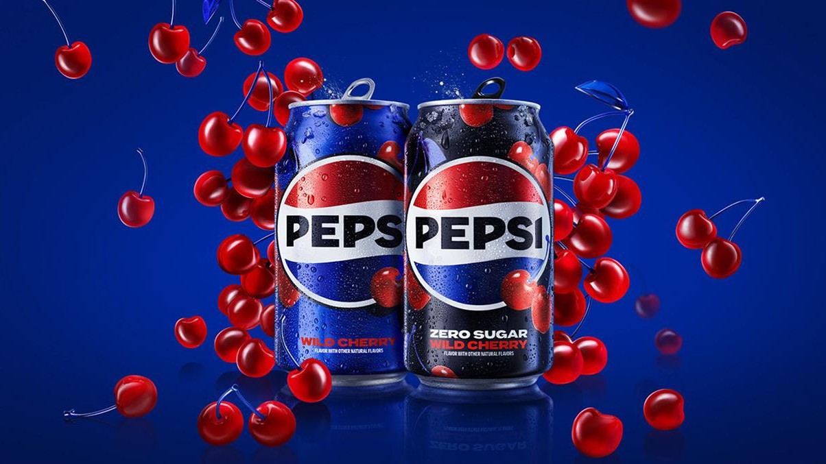Promo shot showing two cans of Pepsi Wild Cherry surrounded by falling cherries