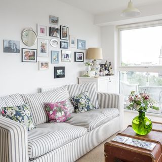 living room with sofa and photo wall