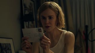 Margaret (Nicole Kidman) holding a postcard in Expats episode 3