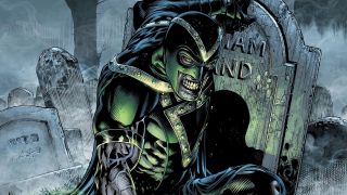 Green Lantern villain Black Hand kneeling next to tombstone with his name etched in it